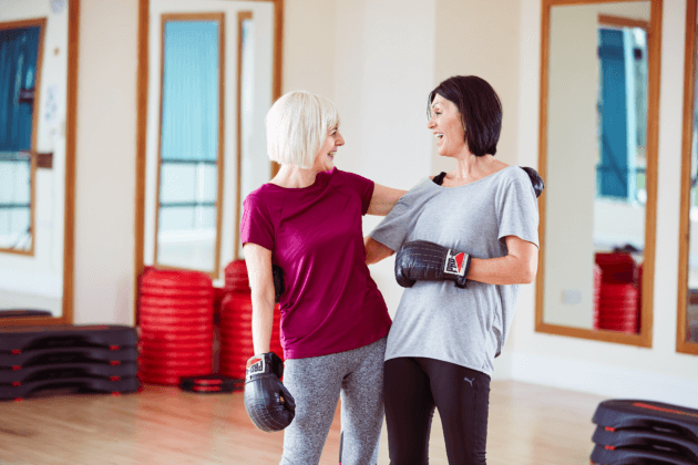 Photo of two women wearing boxing gloves