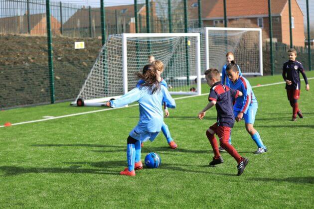 Dorothy Hyman Sports Centre children playing football outdoors