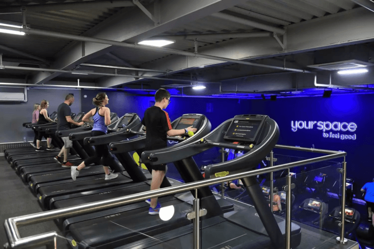 Photo of a group of people exercising on treadmills