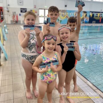 children showing their swimming awards